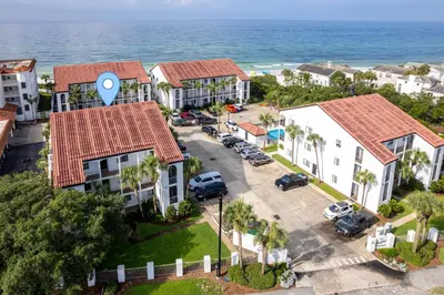 an aerial view of a resort with the ocean at Palms of Seagrove D5, Steps to the Beach, Sleeps 4, Pool, 2 bikes and 5 mins from Seaside in Seagrove Beach