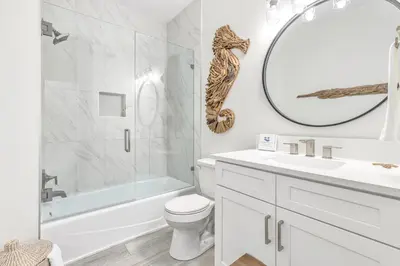 a white bathroom with a sink toilet and a mirror at Palms of Seagrove D5, Steps to the Beach, Sleeps 4, Pool, 2 bikes and 5 mins from Seaside in Seagrove Beach