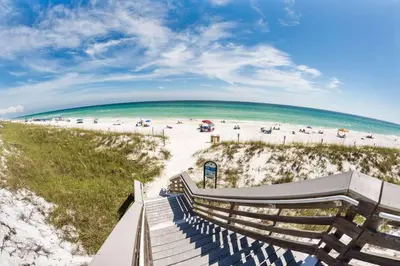 a view of the beach from the stairs at the beach at Treasure Palms - Golf Cart- Bikes - Arcade- Peloton- Near Rosemary - Community Pool in Rosemary Beach