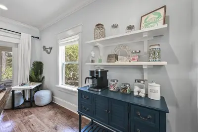 a kitchen with a blue cabinet with a coffee maker on it at Treasure Palms - Golf Cart- Bikes - Arcade- Peloton- Near Rosemary - Community Pool in Rosemary Beach