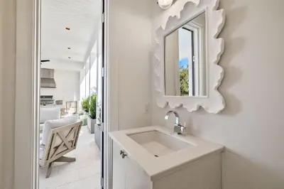 a bathroom with a sink and a mirror on the wall at All Tide Up in Seacrest