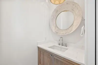 a bathroom with a sink and a mirror at All Tide Up in Seacrest