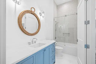 a bathroom with a sink and a toilet and a mirror at All Tide Up in Seacrest