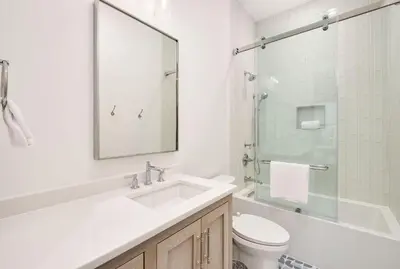 a bathroom with a sink and a toilet and a mirror at Costa Fortune in Inlet Beach