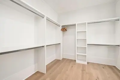 an empty walk in closet with white shelves at Costa Fortune in Inlet Beach