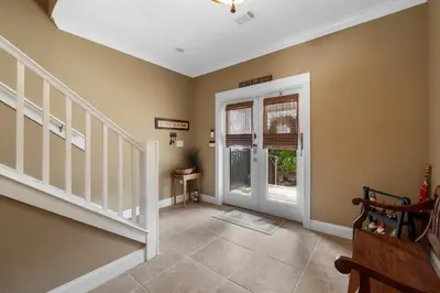 a home hallway with a staircase and a door at 30A Beach House - The Hemingway by Panhandle Getaways in Seacrest