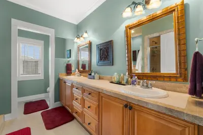 a bathroom with two sinks and a large mirror at 30A Beach House - The Hemingway by Panhandle Getaways in Seacrest