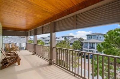 a balcony with a view of a house at 30A Beach House - The Hemingway by Panhandle Getaways in Seacrest