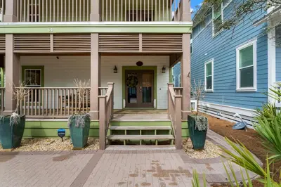 a front porch of a house with a blue building at 30A Beach House - The Hemingway by Panhandle Getaways in Seacrest