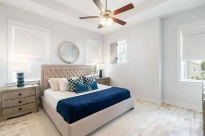 a bedroom with a bed and a ceiling fan at 30A Top Rated! Heated Resort Pool+Golf Cart+Bikes+Bunks+Beach Gear in Watersound Beach