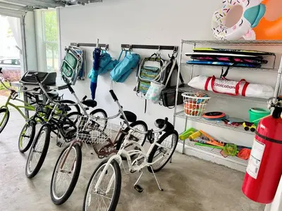 a group of bikes parked in a garage at 30A Top Rated! Heated Resort Pool+Golf Cart+Bikes+Bunks+Beach Gear in Watersound Beach
