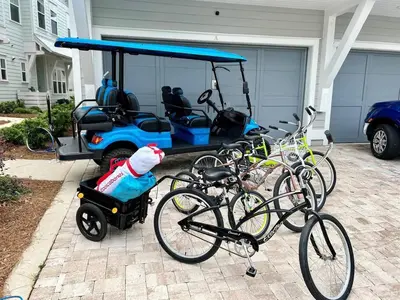 a group of bikes parked next to a golf cart at 30A Top Rated! Heated Resort Pool+Golf Cart+Bikes+Bunks+Beach Gear in Watersound Beach