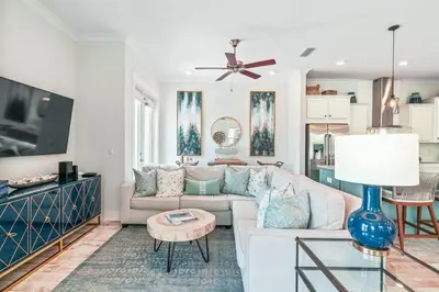 a living room with a couch and a table at 30A Top Rated! Heated Resort Pool+Golf Cart+Bikes+Bunks+Beach Gear in Watersound Beach