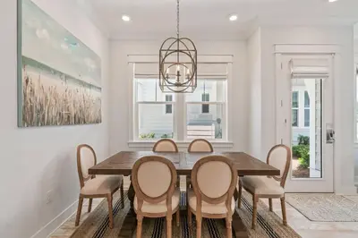 a dining room with a wooden table and chairs at 30A Top Rated! Heated Resort Pool+Golf Cart+Bikes+Bunks+Beach Gear in Watersound Beach