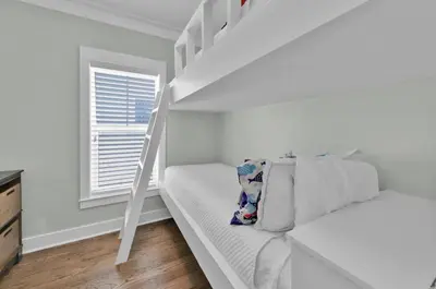 a white bedroom with a bunk bed and a ladder at Anna's Beach House Walk-Out To 30A in Seacrest- Pet-Friendly in Rosemary Beach