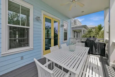 a porch with a table and chairs on a house at Anna's Beach House Walk-Out To 30A in Seacrest- Pet-Friendly in Rosemary Beach