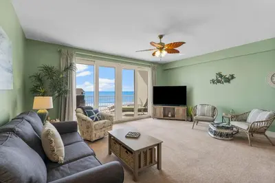 a living room with a couch and a tv at Nautical Nest at Laketown Wharf #1019 by Nautical Properties in Panama City Beach