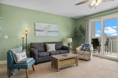 a living room with a couch and chairs at Nautical Nest at Laketown Wharf #1019 by Nautical Properties in Panama City Beach
