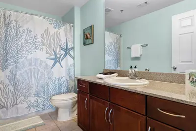 a bathroom with a sink and a toilet and a shower at Nautical Nest at Laketown Wharf #1019 by Nautical Properties in Panama City Beach