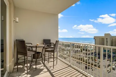 a balcony with a table and chairs and the ocean at Nautical Nest at Laketown Wharf #1019 by Nautical Properties in Panama City Beach