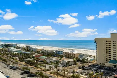 a view of the beach from the balcony of a resort at Nautical Nest at Laketown Wharf #1019 by Nautical Properties in Panama City Beach