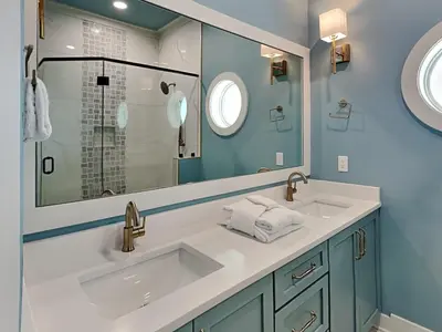 a bathroom with a sink and a mirror at Breezy Beach in Panama City Beach