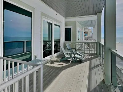 a house with a balcony with a view of the beach at Breezy Beach in Panama City Beach