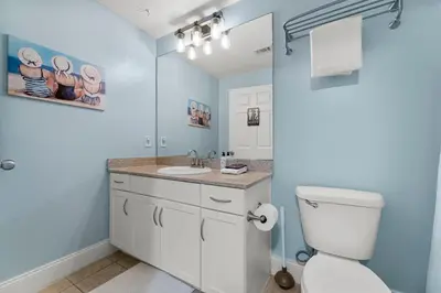 a bathroom with a white toilet and a sink at Laketown Wharf #1734 by Nautical Properties in Panama City Beach