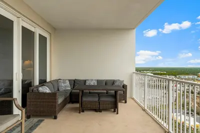 a balcony with a couch and a table at Laketown Wharf #1734 by Nautical Properties in Panama City Beach