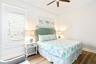 a white bedroom with a bed and a window at Beautiful Home .5mi to Beach SLPS 14! Bikes, 3rd Floor Bunk/Game Room - 2 King Bedrooms in Inlet Beach