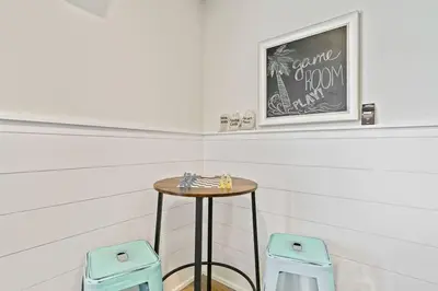 a small table in a room with two stools at Beautiful Home .5mi to Beach SLPS 14! Bikes, 3rd Floor Bunk/Game Room - 2 King Bedrooms in Inlet Beach