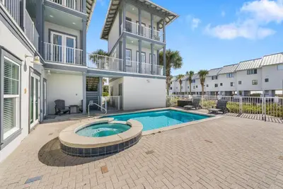 a swimming pool in the courtyard of a house at La Luna in Santa Rosa Beach