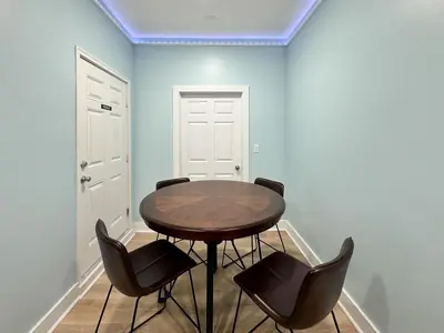 a dining room with a wooden table and chairs at La Luna in Santa Rosa Beach