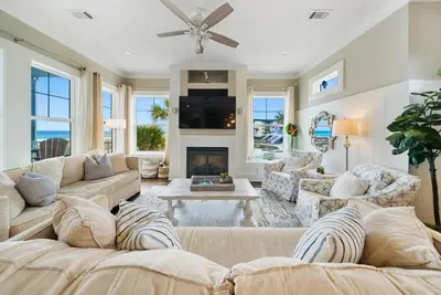 a living room with a couch and a fireplace at La Luna in Santa Rosa Beach