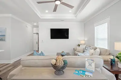 a living room with a couch and a ceiling fan at Laguna Haven! 3BR 2BA Sleeps 7! Your perfect escape! in Panama City Beach