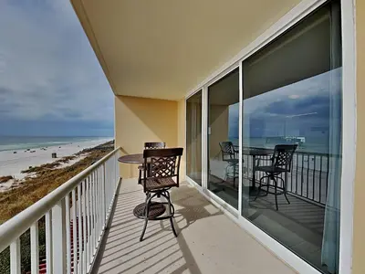 a balcony with a table and chairs and the beach at Majestic Beach Towers I #312 in Panama City Beach