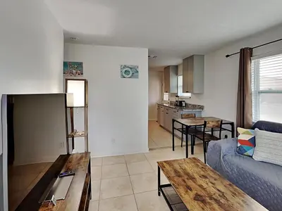 a living room with a couch and a table at Seashell Cottage in Panama City Beach