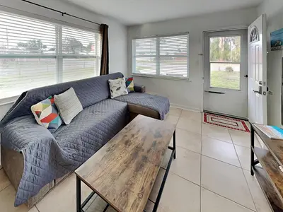 a living room with a couch and a table at Seashell Cottage in Panama City Beach