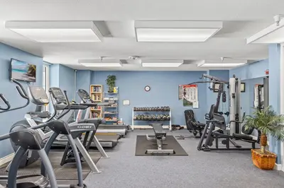 a gym with treadmills and elliptical machines at Grandview Oasis! 3BR 2BA Sleeps 9! Gulf-front tranquility beckons! in Panama City Beach