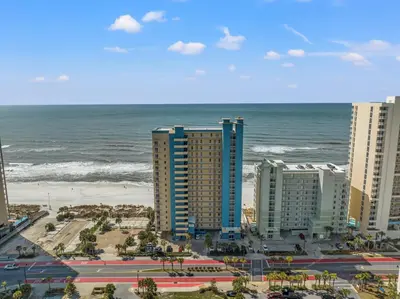 a view of the beach and buildings and the ocean at Grandview Oasis! 3BR 2BA Sleeps 9! Gulf-front tranquility beckons! in Panama City Beach