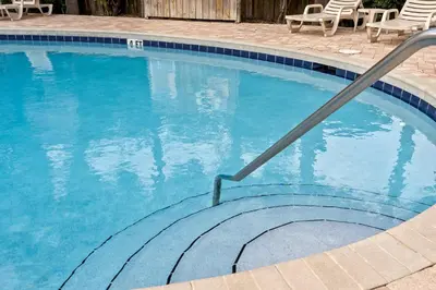 a swimming pool with a stairway leading into the water at Merrimac Resort #43 in Panama City Beach