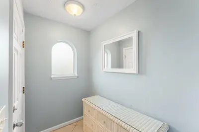a white room with a bench and a mirror at Merrimac Resort #43 in Panama City Beach