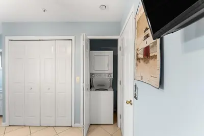 a white laundry room with a washer and dryer at Merrimac Resort #43 in Panama City Beach