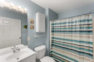 a bathroom with a white toilet and a sink at Merrimac Resort #43 in Panama City Beach