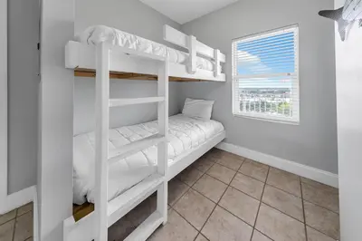 a bedroom with two bunk beds and a window at Laketown Wharf 801 by Emerald Coast Retreats in Panama City Beach