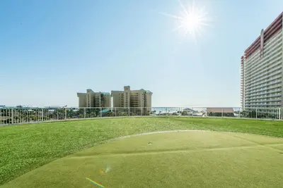 a golf ball on a green field with buildings in the background at Laketown Wharf 801 by Emerald Coast Retreats in Panama City Beach