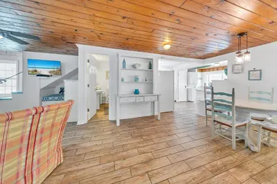 a dining room with a wooden ceiling and a table at If Its The Beaches by Emerald Coast Retreats in Panama City Beach