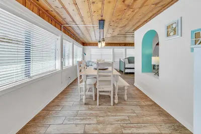 a dining room with a table and chairs at If Its The Beaches by Emerald Coast Retreats in Panama City Beach