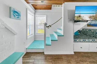a staircase in a house with blue steps at If Its The Beaches by Emerald Coast Retreats in Panama City Beach