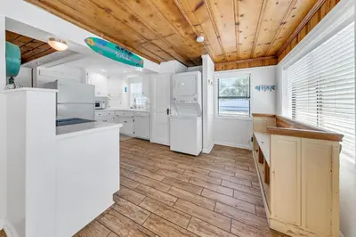 a kitchen with white appliances and a wooden ceiling at If Its The Beaches by Emerald Coast Retreats in Panama City Beach